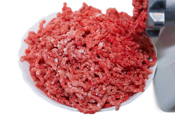 fresh minced meat with meat grinder on white background