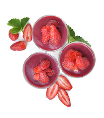 top view on red fruit coulis and strawberries in glass isolated on white background