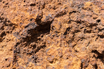Natural volcanic stone in red and brown. Surface of the volcanic rock