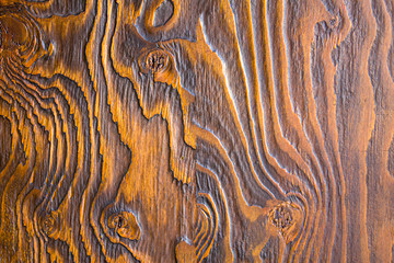 bright yellow black wood texture with deep relief close-up. rough natural surface