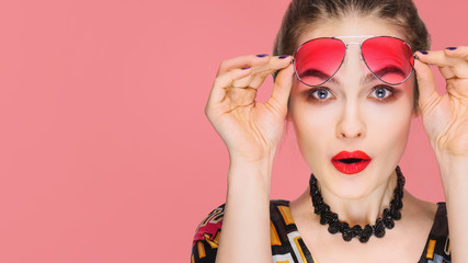  Portrait of Beautiful young Woman with Colored Glasses. Beauty Fashion. Perfect Make-up