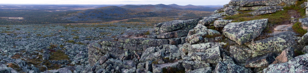 Cliff, mountains, stone wall and forest panoramic view in autumn. Fall colors - ruska time in Pyha-Nattanen. Urho Kekkonen National Park in north Finland. Laplan