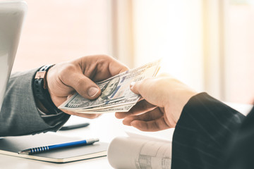 Businessman hand sending money to another business person. Transaction, payment, salary and banking...