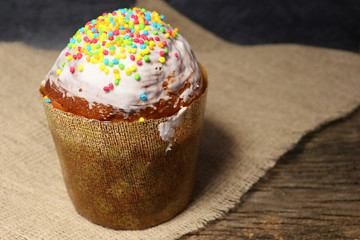 Easter cake in white glaze and sprinkling of colored sweet balls.