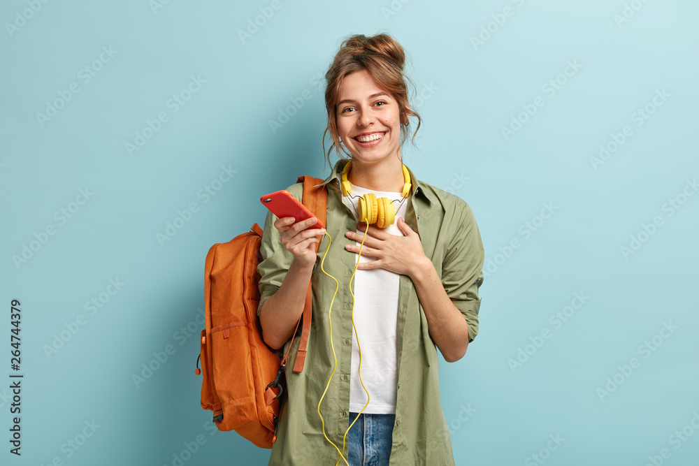 Wall mural indoor shot of pleased european student happy to receive message of congratulation after passing exa