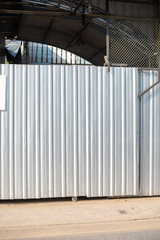 Aluminum Metal corrugated door sheet with black steel column structure.