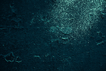 Vintage azure background. Rough painted wall of turquoise color. Imperfect plane of cyan colored. Uneven old decorative toned backdrop of aqzure tint. Texture of teal hue. Ornamental stony surface.