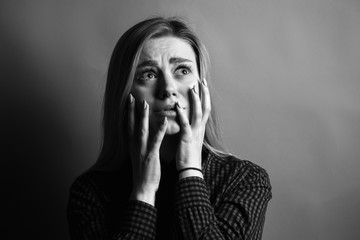 Portrait of scared young woman. Black and white - obrazy, fototapety, plakaty