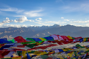  Buddhist Tibetan multicolored prayer flags close up in the wind on a blurred background of mountains