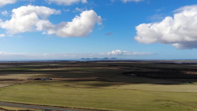 Heimaey part of westman Islands archipelago video footage of the southern coast of Iceland on a sunny day with fields and atlantic ocean