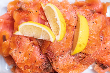 Salmon or trout slices served with lemon