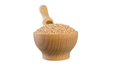 crushed spelt in wooden bowl and scoop isolated on white background. nutrition. bio. natural food...