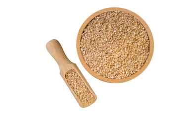 crushed spelt in wooden bowl and scoop isolated on white background. nutrition. bio. natural food ingredient.top view.