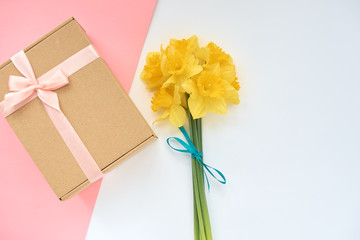 bouquet of daffodils with gift box on a white background