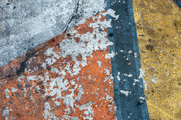 Fresh closeup orange, white and yellow color of street texture, cropped only details showing rough painted and accidental patterns created by car wheels and weathers.
