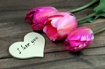 Fototapeta na wymiar I love you. tulips on a wooden table. 