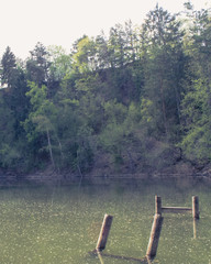 Old broken pier on water