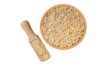 pearl barley in wooden bowl and scoop isolated on white background. nutrition. bio. natural food ingredient.top view.