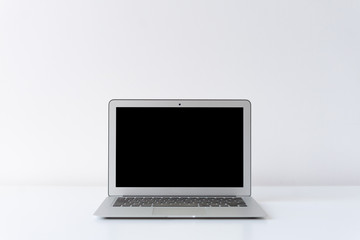 Open laptop on the desk with white background