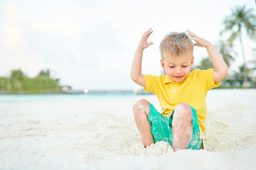 Three year old toddler boy on beach