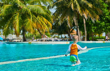 Toddler boy in resort swimming pool