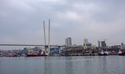 Fototapeta na wymiar Russia. Vladivostok - April 2019: Bridge over The Golden horn Bay (Zolotoy Rog)