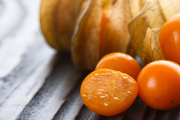 juicy winter cherry on a wooden rustic background
