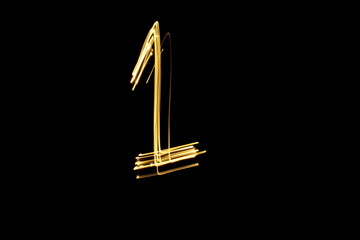 Long exposure, light painting photography.  Single number in a vibrant neon metallic yellow gold...