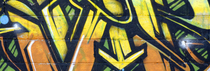 Fragment of colored street art graffiti paintings with contours and shading close up