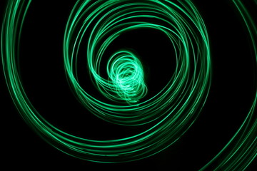 Long exposure, light painting photography.  Vibrant neon streaks of colour against a black background