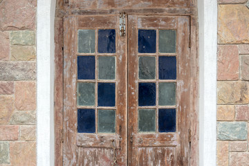 Fototapeta na wymiar Vintage architecture wooden door decorated with colorful stained glass