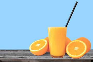 Glass of fresh Orange Juice on vintage wood table and blue background