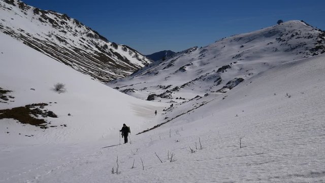 Matese Lake, Campania, Italy - february 2 2019: snowshoeing on snow covered plateau with blue sky. Matese Mounts landscape, Campo dell'esule (Field of the exile), Campo dell'arco (field of the arch)
