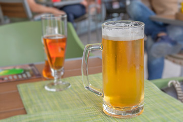 Glass of light beer on a restaurant table