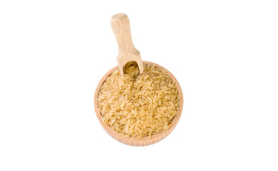 brown rice in wooden bowl and scoop isolated on white background. nutrition. bio. natural food ingredient.top view.