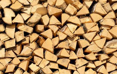 A woodpile of fresh, natural freshly cut and chopped wood.