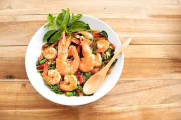 stir fried shrimp basil  on wood background