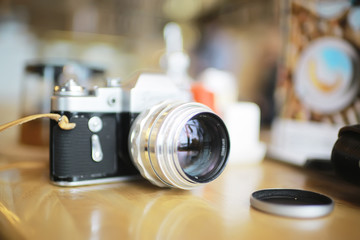 Fototapeta na wymiar blurred background with vintage camera / photo old camera, unusual vintage, hipster camera