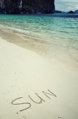 Love and romance. The inscription on the sand. Holidays by the sea.
