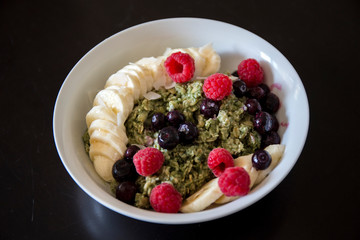 Matcha  Oatmeal porridge with ripe berries and banana