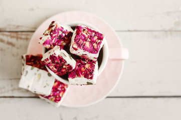 Nougat with rose petals in a pink cup. Lebanese sweets. Arabic dessert