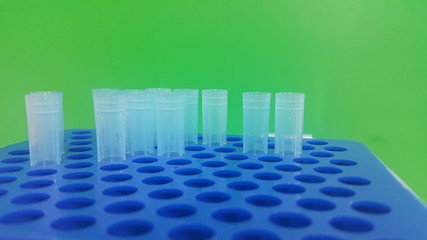 Close up view of blue micro litre tips in microtip box with empty holes.