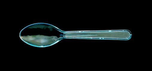 Plastic spoon on black background