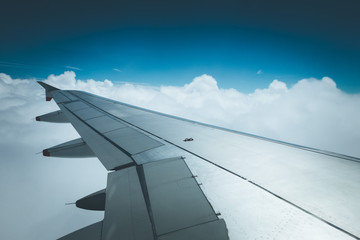 Fototapeta premium Airplane wing through the aircraft window. Greenhouse effect, global warming.
