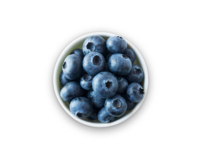 Blueberries in a white bowl. Ripe blueberries with copy space for text. Blueberry isolated on white. Bilberries  on a white background. Top view.