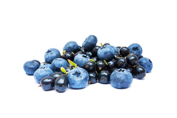 Blueberries and black currants isolated on white bacground. Ripe blueberries with copy space for text. Blueberry isolated on white. Bilberries and currants on a white background. Top view.
