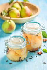 Natural and juicy pickled pears on wooden table