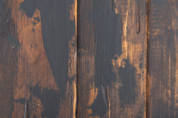The old wooden surface background, scuffed boards with black paint stains.