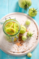 Top view of pickled green tomatoes in the jar