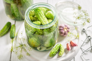 Closeup of fresh pickled green cucumber on white table